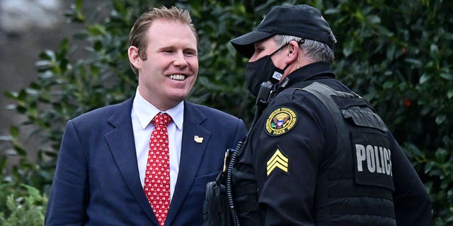 Andrew Giuliani, special assistant to U.S. President Donald Trump and son of Rudy Giuliani, speaks to a Secret Service officer outside the West Wing of the White House in Washington, U.S., January 15, 2021. REUTERS/Erin Scott