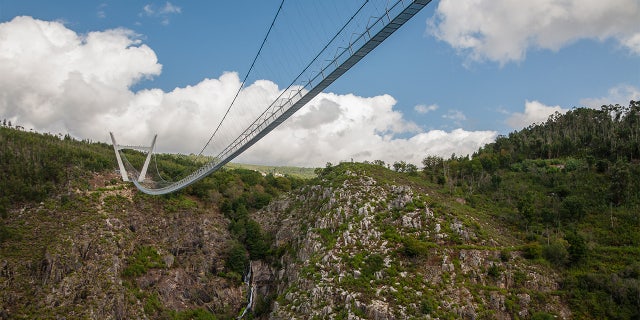 The bridge traverses the fast moving River Paiva in the Arouca Geopark, suspended 574 feet above the water.