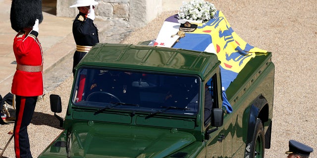 Members of the armed forces pay tribute to the coffin of Britain's Prince Philip, Duke of Edinburgh in the quadrangle ahead of the ceremonial funeral procession.