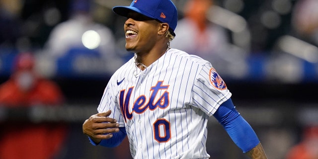 New York Mets starting pitcher Marcus Stroman celebrates after the Philadelphia Phillies' Rhys Hoskins grounded into a double play during the sixth inning of the second game of a doubleheader April 13, 2021, in New York.
