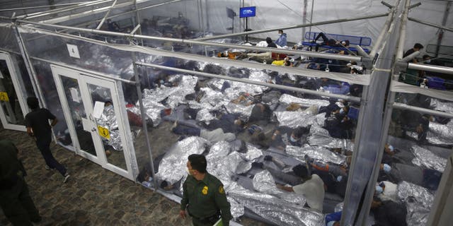 Young minors lie inside a pod at the Donna Department of Homeland Security holding facility, the main detention center for unaccompanied children in the Rio Grande Valley run by U.S. Customs and Border Protection in Donna, Texas. (AP Photo/Dario Lopez-Mills,Pool)
