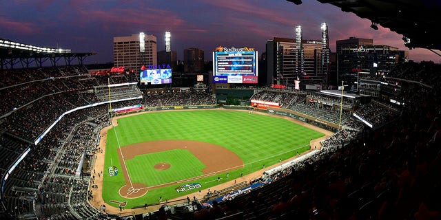 Ground crews prepare the field at Sun Trust Park, now known as Truist Park, ahead of Game 3 of MLB baseball's National League Division Series between the Atlanta Braves and the Los Angeles Dodgers in Atlanta on Oct. 7, 2018.  (Associated Press)