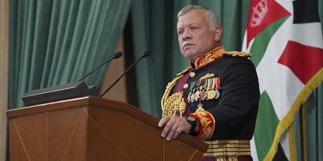 FILE - In this Dec. 10, 2020 photo released by the Royal Hashemite Court, Jordan's King Abdullah II gives a speech during the inauguration of the 19th Parliament's non-ordinary session, in Amman Jordan. Jordan’s army chief of staff says the half-brother of King Abdullah II was asked to "stop some movements and activities that are being used to target Jordan’s security and stability." The army chief of staff denied reports Saturday, April 3, 2021, that Prince Hamzah was arrested. He said an investigation is still ongoing and its results will be made public "in a transparent and clear form." (Yousef Allan/The Royal Hashemite Court via AP, File)
