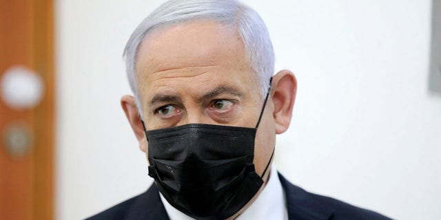 Israeli Prime Minister Benjamin Netanyahu attends a hearing evidence stage for his trial over alleged corruption crimes, at the Jerusalem district court, in Salah El-Din, East Jerusalem, Monday, April 5, 2021. Netanyahu was back in court for his corruption trial on Monday as the country's political parties were set to weigh in on whether he should form the next government after a closely divided election or step down to focus on his legal woes. (Abir Sultan/Pool Photo via AP)