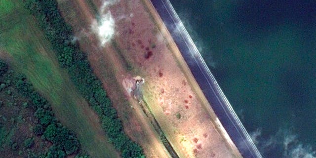 This Monday, aprile 5, 2021, image provided by Maxar Technologies shows a view of a breach in a retaining pond at the 77-acre Piney Point reservoir in Manatee County, just south of the Tampa Bay area, in Florida.