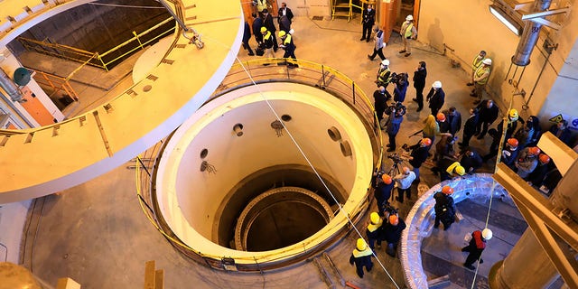 In this file photo dated Monday, Dec. 23, 2019, released by the Atomic Energy Organization of Iran, showing technicians at the Arak heavy water reactor's secondary circuit, as officials and media visit the site, near Arak, 150 miles southwest of the capital Tehran, Iran. 