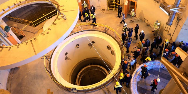 In this file photo dated Monday, Dec. 23, 2019, released by the Atomic Energy Organization of Iran, showing technicians at the Arak heavy water reactor's secondary circuit, as officials and media visit the site, near Arak, 150 miles southwest of the capital Tehran, Iran. 