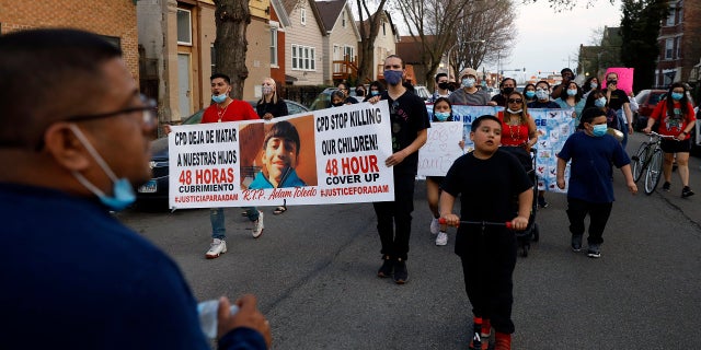 Members of Chicago's Little Village Community Council march on Tuesday, April 6, 2021 to protest against the death of 13-year-old Adam Toledo, who was shot by a Chicago Police officer at about 2 a.m. on March 29 in an alley west of the 2300 block of South Sawyer Avenue near Farragut Career Academy High School. (AP Photo/Shafkat Anowar)