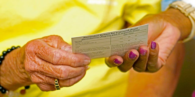 Linda Busby, 74, receives a vaccination card after receiving a shot of the Johnson &amp;amp; Johnson COVID-19 vaccine at the Aaron E. Henry Community Health Service Center, Wednesday, April 7, 2021, in Clarksdale, Miss. Busby joined a group of seniors from the Rev. S.L.A. Jones Activity Center for the Elderly that were given a ride to the health center for their vaccinations. The Mississippi Department of Human Services is in the initial stages of teaming up with community senior services statewide to help older residents get vaccinated. (AP Photo/Rogelio V. Solis)
