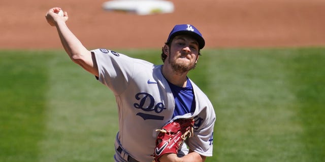 Los Angeles Dodgers pitcher Trevor Bauer throws against the Oakland Athletics during the first inning of a baseball game in Oakland, Calif., Wednesday, April 7, 2021. 