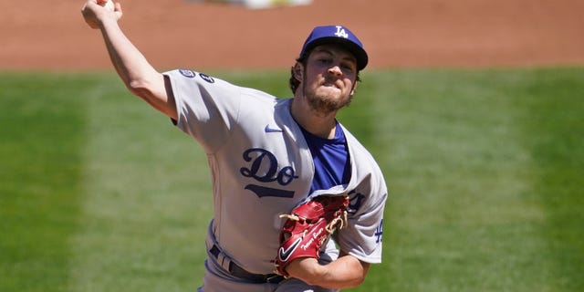 Los Angeles Dodgers pitcher Trevor Bauer throws against the Oakland Athletics during the first inning of a baseball game in Oakland, Calif., Wednesday, April 7, 2021.