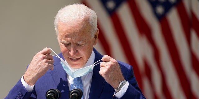 President Joe Biden removes his face mask to speak about gun violence prevention in the Rose Garden at the White House, Thursday, April 8, 2021, in Washington. (AP Photo/Andrew Harnik)