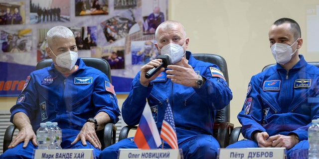 In this image provided by NASA, from left, U.S. astronaut Mark Vande Hei, Russian cosmonauts Oleg Novitsky and Pyotr Dubrov, members of the main crew to the International Space Station (ISS), attend a news conference in the Baikonur Cosmodrome, Kazakhstan, Thursday, April 8, 2021. (Bill Ingalls/NASA via AP