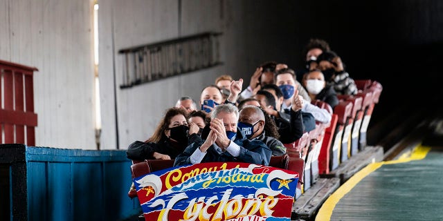 New York City Mayor Bill de Blasio finishes a ride on the Cyclone rollercoaster after attending the ribbon cutting and seasonal opening of the Coney Island amusement park area, Friday, April 9, 2021, in the Brooklyn borough of New York. Coney Island's illustrious amusement parks are reopening Friday after the coronavirus pandemic shuttered them all last year. AP Photo/John Minchillo)