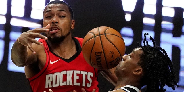 Los Angeles Clippers guard Terance Mann, right, loses control of the ball while under pressure from Houston Rockets forward Sterling Brown during the second half of an NBA basketball game Friday, April 9, 2021, in Los Angeles. (AP Photo/Mark J. Terrill)