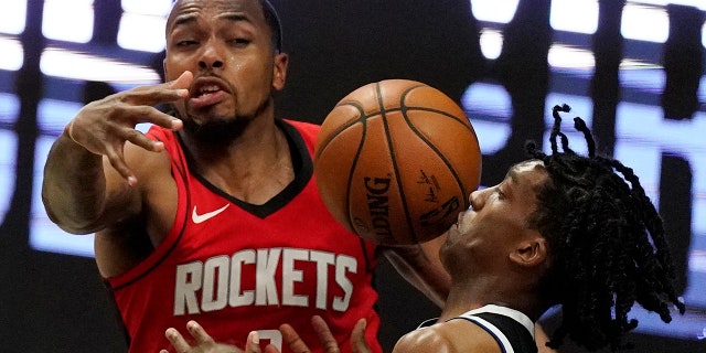 Los Angeles Clippers guard Terance Mann, right, loses control of the ball while under pressure from Houston Rockets forward Sterling Brown during the second half of an NBA basketball game Friday, April 9, 2021, in Los Angeles. (AP Photo/Mark J. Terrill)