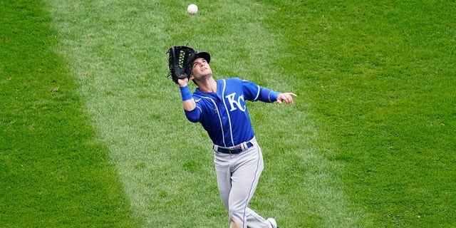 Kansas City Royals left fielder Andrew Benintendi catches the ball of Louis Robert of the Chicago White Sox during the fourth inning of a baseball game in Chicago, Sunday, April 11, 2021.  (AP Photo/Nam Y. Huh)
