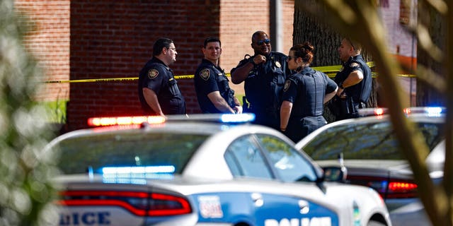 Knoxville police work the scene following a shooting at Austin-East Magnet High School in Knoxville, Tenn., Monday, April 12, 2021. (AP Photo/Wade Payne)