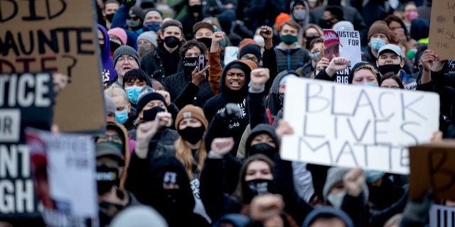 A crowd gathers at the Brooklyn Center Police Department in Brooklyn Center, Minn., Monday, April 12, 2021, for a No Justice No Peace rally following the police shooting death of Daunte Wright.