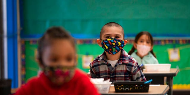 Kindergarten students sit in their classroom on the first day of in-person learning at Maurice Sendak Elementary School in Los Angeles, Tuesday, April 13, 2021. 