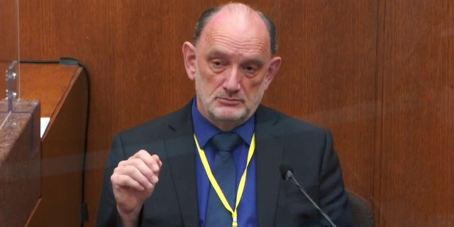 Dr. David Fowler, a retired forensic pathologist and former chief medical examiner for the state of Maryland testifies as Hennepin County Judge Peter Cahill presides, Wednesday, April 14, 2021, in the trial of former Minneapolis police Officer Derek Chauvin. (Court TV via AP, Pool)