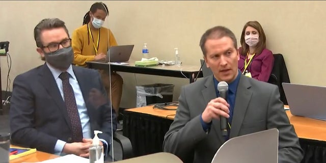 Defense attorney Eric Nelson, left, and defendant, former Minneapolis police officer Derek Chauvin address Hennepin County Judge Peter Cahill during motions before the court in the trial of Chauvin, at the Hennepin County Courthouse in Minneapolis. (Court TV via AP, Pool)