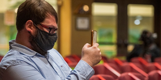 Chris Lambert, musician and recording engineer, records the arraignment of Paul Flores, and his father Ruben Flores, at the San Luis Obispo Superior Court in San Luis Obispo, Calif., Thursday, April 15, 2021. Lambert started a podcast to document the 1996 disappearance of Kristin Smart, who was a college student at Cal Poly and lived in Muir Hall when she disappeared. On Tuesday, April 13, 2021, the San Luis Obispo County sheriff announced arrests in the 25-year-old case, crediting Lambert with helping bring in witnesses that propelled the case forward. (AP Photo/Nic Coury)