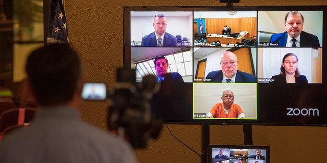 Defendants Paul Flores, top left, and his father Ruben Flores, bottom center, appear via video conference during their arraignment, Thursday, April 15, 2021, in San Luis Obispo Superior Court in San Luis Obispo, Calif. The father and son were arrested on Tuesday, April 13, 2021, in connection with the 1996 disappearance of Kristin Smart, a college student at California Polytechnic University San Luis Obispo. (AP Photo/Nic Coury)