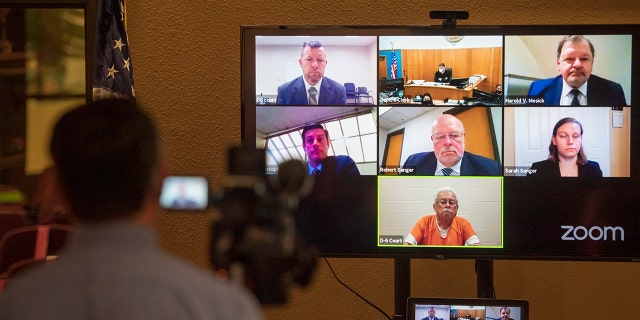 Defendants Paul Flores, top left, and his father Ruben Flores, bottom center, appear via video conference during their arraignment, Thursday, April 15, 2021, in San Luis Obispo Superior Court in San Luis Obispo, Calif. The father and son were arrested on Tuesday, April 13, 2021, in connection with the 1996 disappearance of Kristin Smart, a college student at California Polytechnic University San Luis Obispo. (AP Photo/Nic Coury)