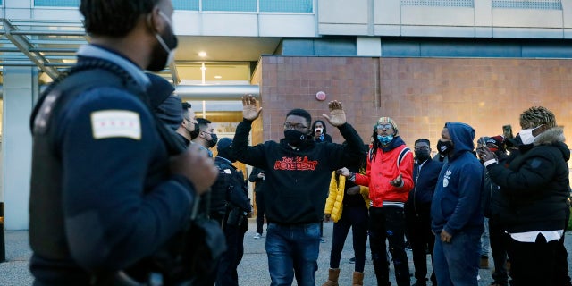 Activist Ja'Mal Green reacts as he walks towards a line of police officers outside Chicago police headquarters during a rally after the body camera video release of fatal police shooting of 13-year-old Adam Toledo on Thursday, April 15, 2021. (AP Photo/Shafkat Anowar)