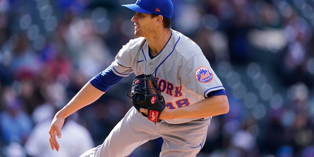 New York Mets starting pitcher Jacob deGrom watches a throw to Colorado Rockies' C.J. Cron during the fourth inning of a doubleheader, April 17, 2021, in Denver.