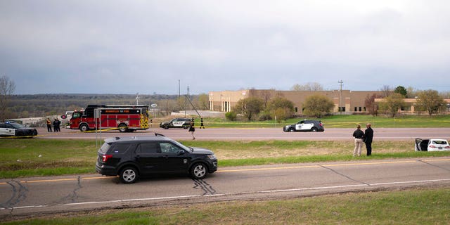 Authorities investigate the scene of an officer-involved shooting Sunday, April 18, 2021, in Burnsville, Minn. 