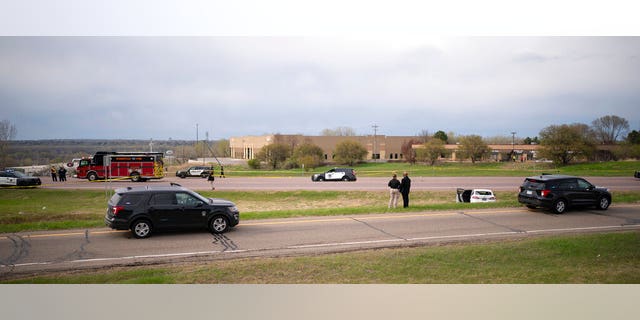 Authorities investigate the scene of an officer-involved shooting Sunday, April 18, 2021, in Burnsville, Minn.