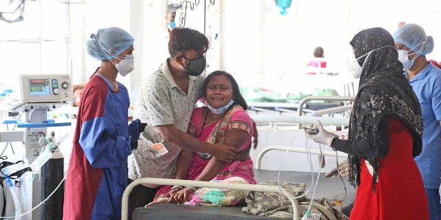 A woman cries after her husband died of a leakage in the oxygen plant of a hospital in Nashik, in the Indian state of Maharashtra, Wednesday, April 21, 2021. A local administrator in western India says 22 patients have died in a hospital when their oxygen supply was interrupted by a leakage in a supply tank. The official says the oxygen supply has since been resumed to other patients. (AP Photo)
