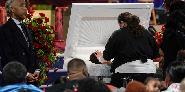 Katie Wright, mother of Daunte Wright, places her hand on her son during visitation, Wednesday, April 21, 2021, in Minneapolis. (Associated Press)