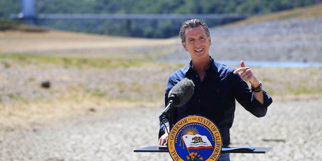 California Gov. Gavin Newsom speaks at a news conference in the parched basin of Lake Mendocino in Ukiah, Calif., Wednesday, April 21, 2021, where he announced he would proclaim a drought emergency for Mendocino and Sonoma counties. (Kent Porter/The Press Democrat via AP)