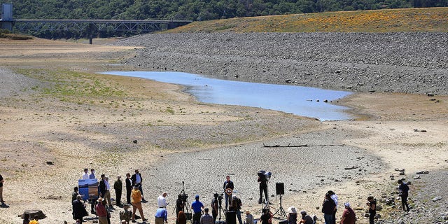 California Gov. Gavin Newsom holds a news conference in the parched basin of Lake Mendocino in Ukiah, Calif., Wednesday, April 21, 2021, where he announced he would proclaim a drought emergency for Mendocino and Sonoma counties. (Kent Porter/The Press Democrat via AP)