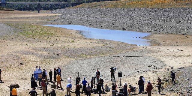 California Gov. Gavin Newsom holds a news conference in the parched basin of Lake Mendocino in Ukiah, Calif., Wednesday, April 21, 2021, where he announced he would proclaim a drought emergency for Mendocino and Sonoma counties. (Kent Porter/The Press Democrat via AP)