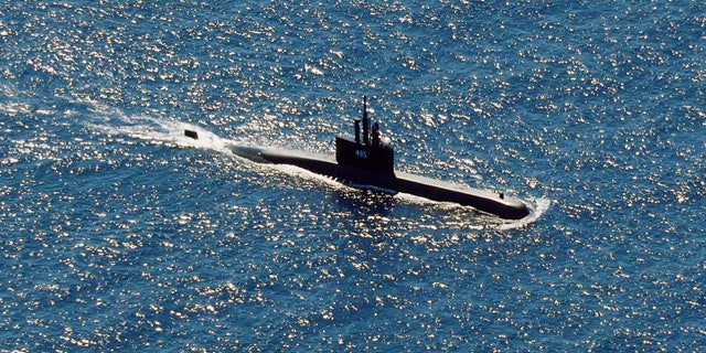 In this aerial photo taken from a maritime patrol aircraft of 800 Air Squadron of the 2nd Air Wing of Naval Aviation Center (PUSPENERBAL), the Indonesian Navy submarine KRI Alugoro sails during a search for KRI Nanggala, another submarine that went missing while participating in a training exercise on Wednesday, in the waters off Bali Island, Indonesia, Thursday, April 22, 2021. (AP Photo/Eric Ireng)