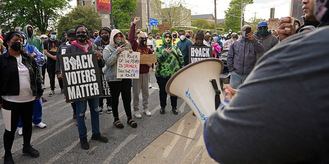 People gather for a peaceful demonstration, Thursday, April 22, 2021, in Elizabeth City, N.C., protesting the shooting of Andrew Brown Jr., 42, by a deputy sheriff trying to serve a search warrant. (AP Photo/Gerry Broome)