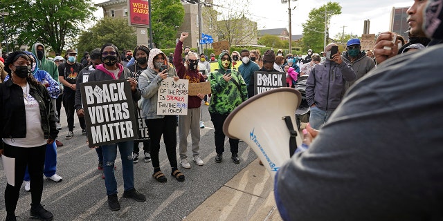 People gather for a peaceful demonstration, Thursday, April 22, 2021, in Elizabeth City, N.C., protesting the shooting of Andrew Brown Jr., 42, by a deputy sheriff trying to serve a search warrant. (AP Photo/Gerry Broome)