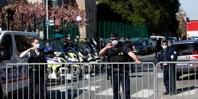Police officers block the access with barriers next to the police station in Rambouillet, south west of Paris, Friday, April 23, 2021. (AP Photo/Michel Euler)