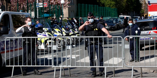 Police officers block the access with barriers next to the police station in Rambouillet, south west of Paris, Friday, April 23, 2021. (AP Photo/Michel Euler)