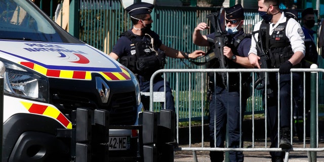Police officers block the access with barriers next to the police station in Rambouillet, south west of Paris, Friday, April 23, 2021. (AP Photo/Michel Euler)