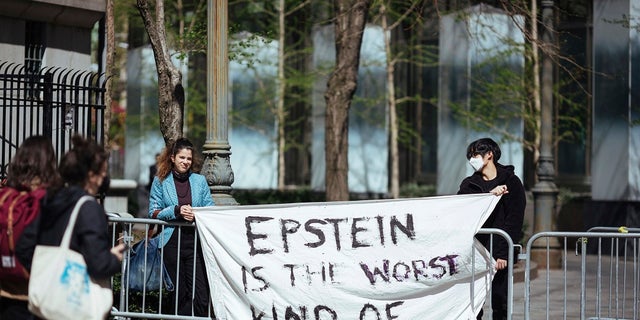 Activists protesting Jeffrey Epstein's associate Ghislaine Maxwell stand in front of a federal court in New York City. (AP Photo/Kevin Hagen)