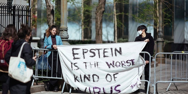 Activists protesting Jeffrey Epstein's associate Ghislaine Maxwell stand in front of a federal court in New York City. (AP Photo/Kevin Hagen)