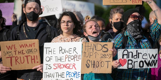 Demonstrators organize on Colonial Avenue to march, Thursday, April 22, 2021, in Elizabeth City, N.C., in reaction to the death of Andrew Brown Jr. (Robert Willett/The News & Observer via AP)
