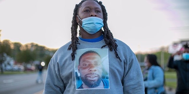 A demonstrator wears a shirt with an image of Andrew Brown Jr. on it during a march in Elizabeth City, N.C., in reaction to the death of Brown, who was shot and killed by a Pasquotank County Deputy Sheriff earlier in the week. (Robert Willett/The News & Observer via AP)