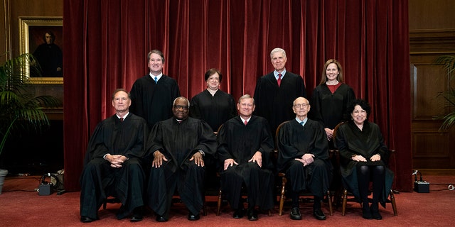 Seated from left are Justices Samuel Alito and Clarence Thomas, Chief Justice John Roberts, and Justices Stephen Breyer and Sonia Sotomayor. Standing from left are Justices Brett Kavanaugh, Elena Kagan, Neil Gorsuch and Amy Coney Barrett.
