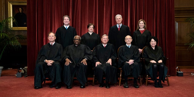 Seated from left are Justices Samuel Alito and Clarence Thomas, Chief Justice John Roberts, and Justices Stephen Breyer and Sonia Sotomayor. Standing from left are Justices Brett Kavanaugh, Elena Kagan, Neil Gorsuch and Amy Coney Barrett.